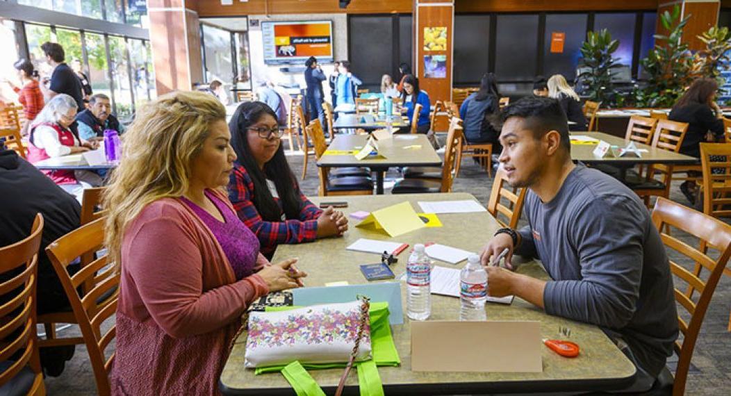 Students working the annual immigration fair.